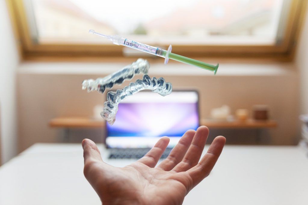 a hand holding a toothbrush