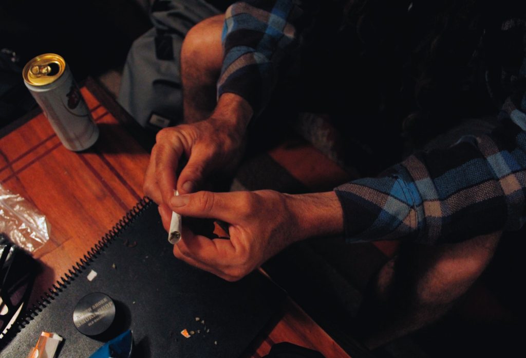 a close-up of a person holding a cigarette