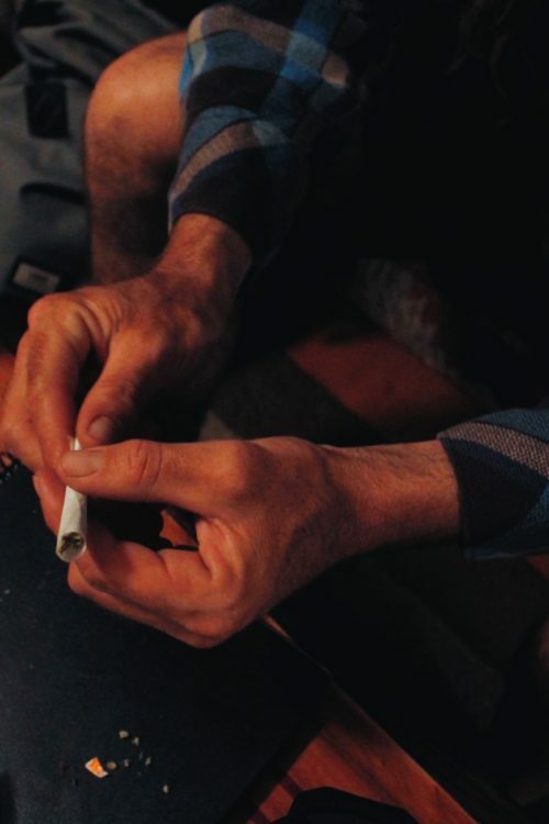 a close-up of a person holding a cigarette