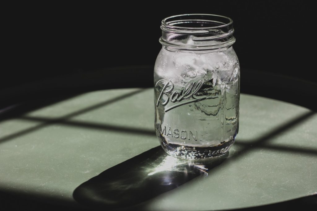 a glass jar with a handle