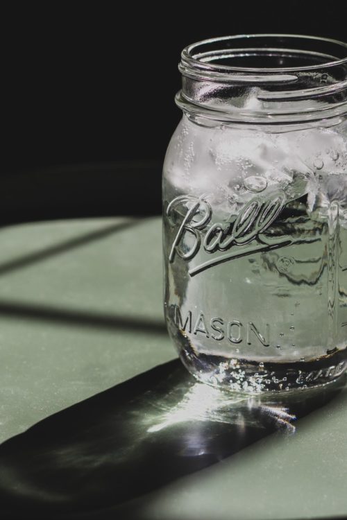 a glass jar with a handle