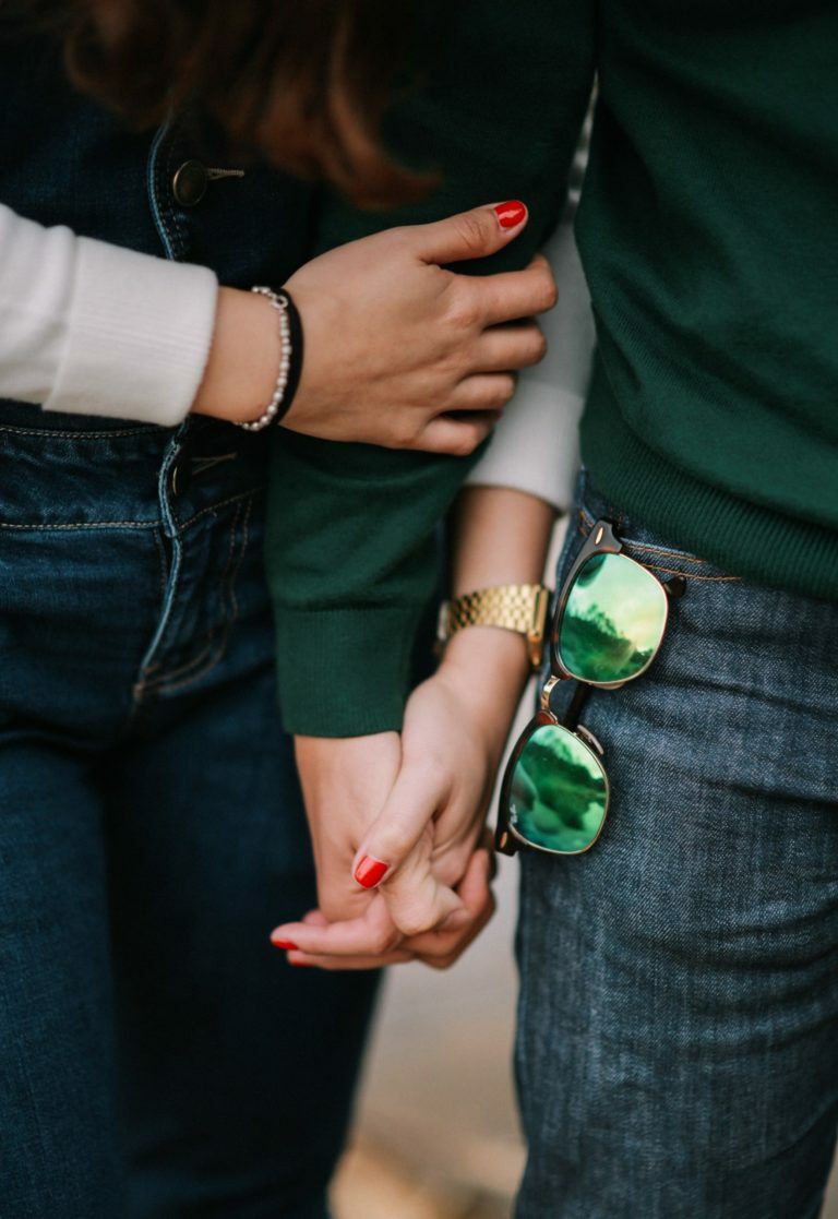 a person holding a green bottle