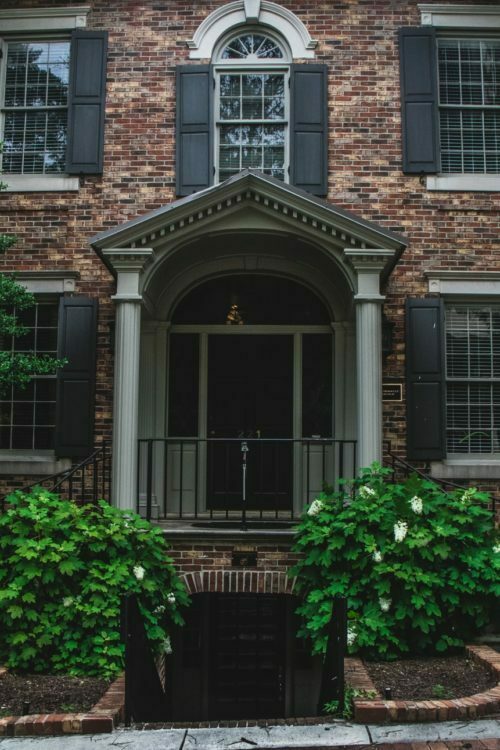 a brick building with a gate and a gate in front of it