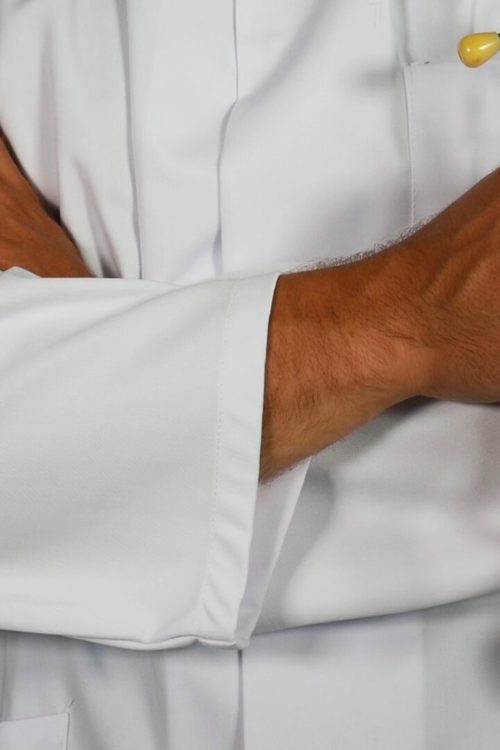 a person's arm with a white shirt and a white pillow